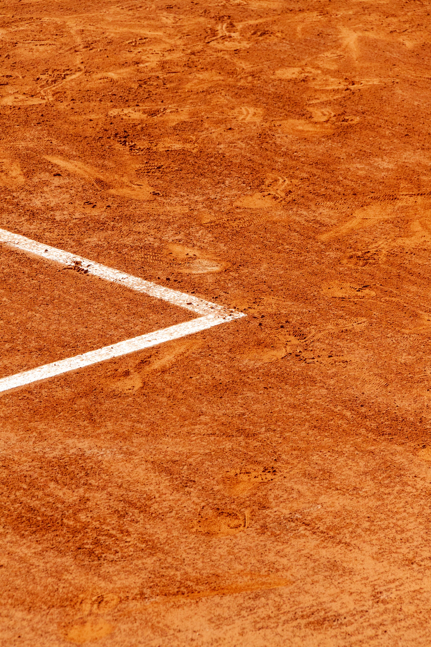 White lines marking a clay court corner