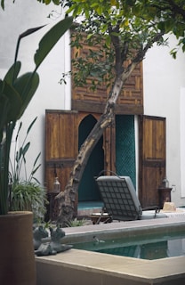 A relaxing courtyard with a pool and wooden door.