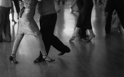 People are dancing on a wooden floor