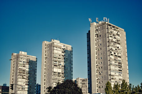 Skyscrapers stand tall against a brilliant blue sky.
