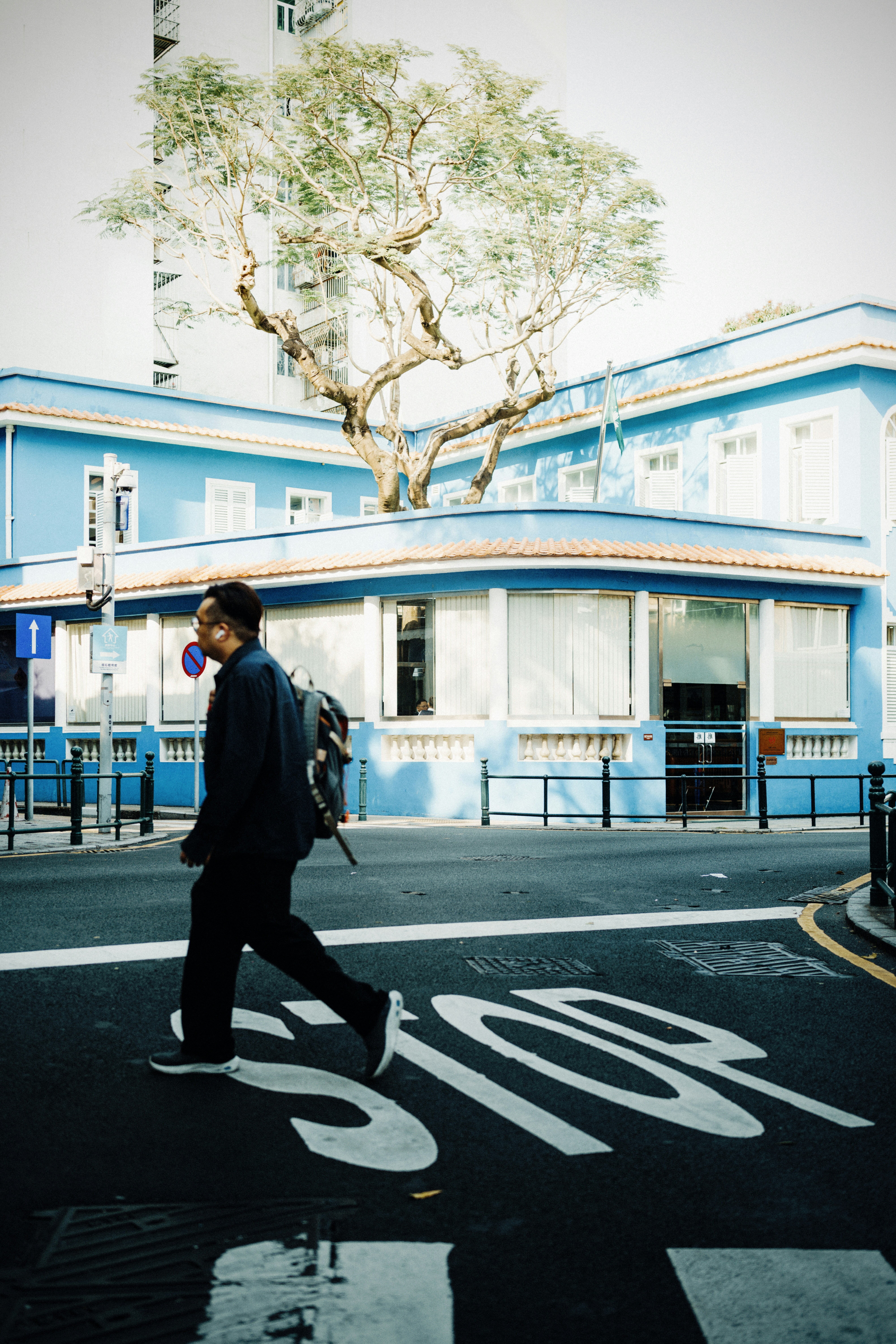 A man walks across a crosswalk.