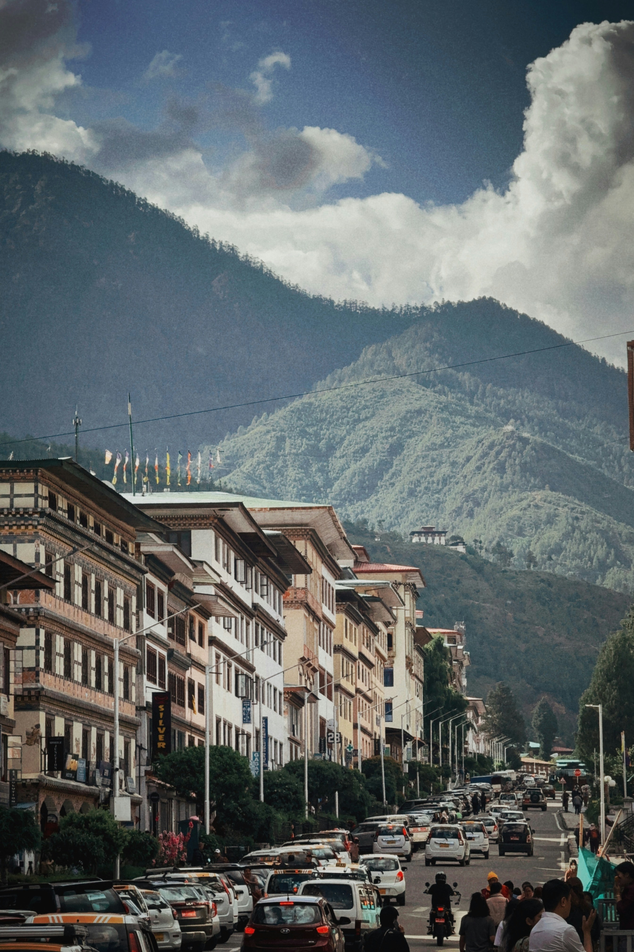 A city street view with mountains in the background.