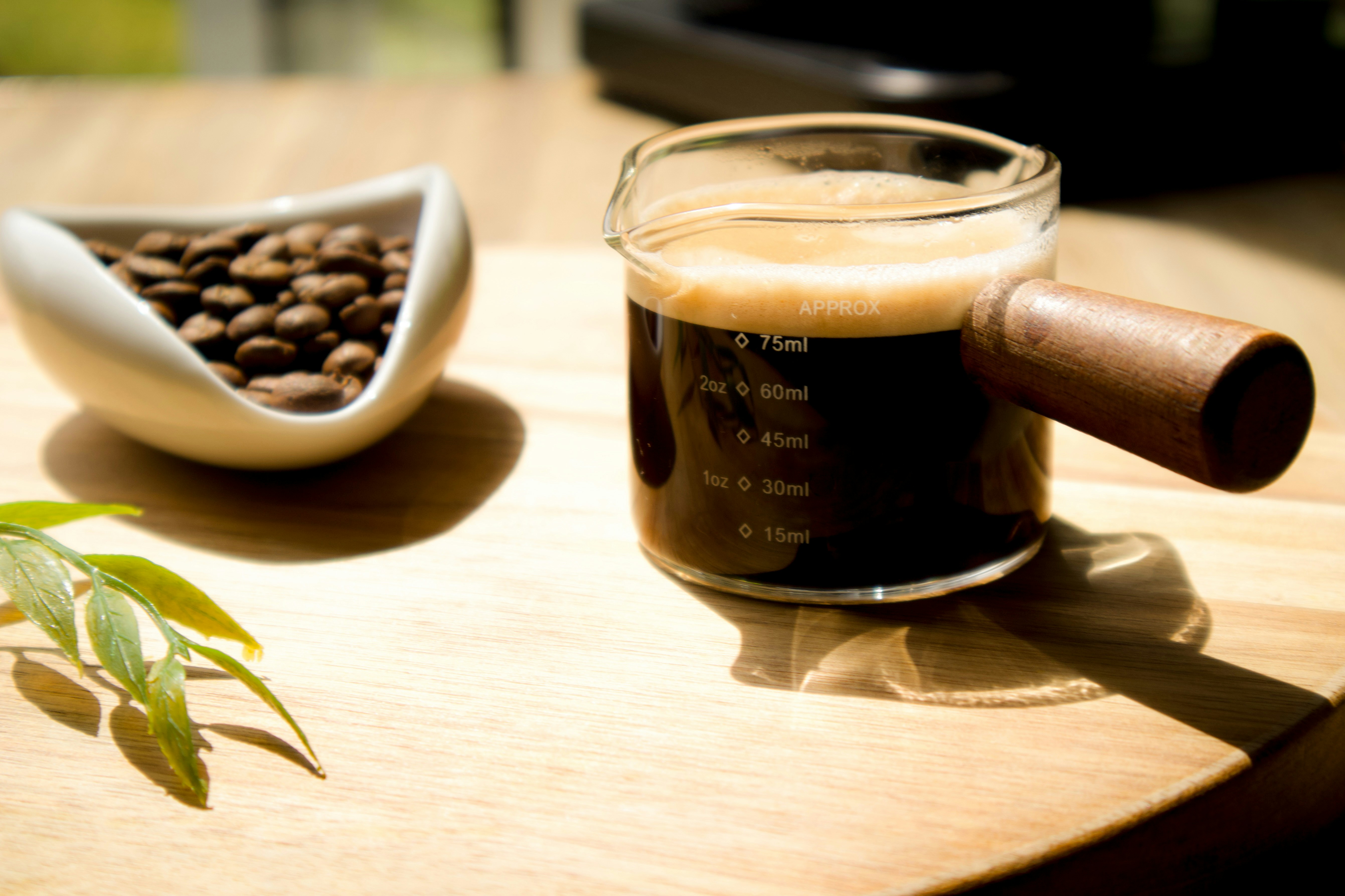 Freshly brewed coffee alongside coffee beans.