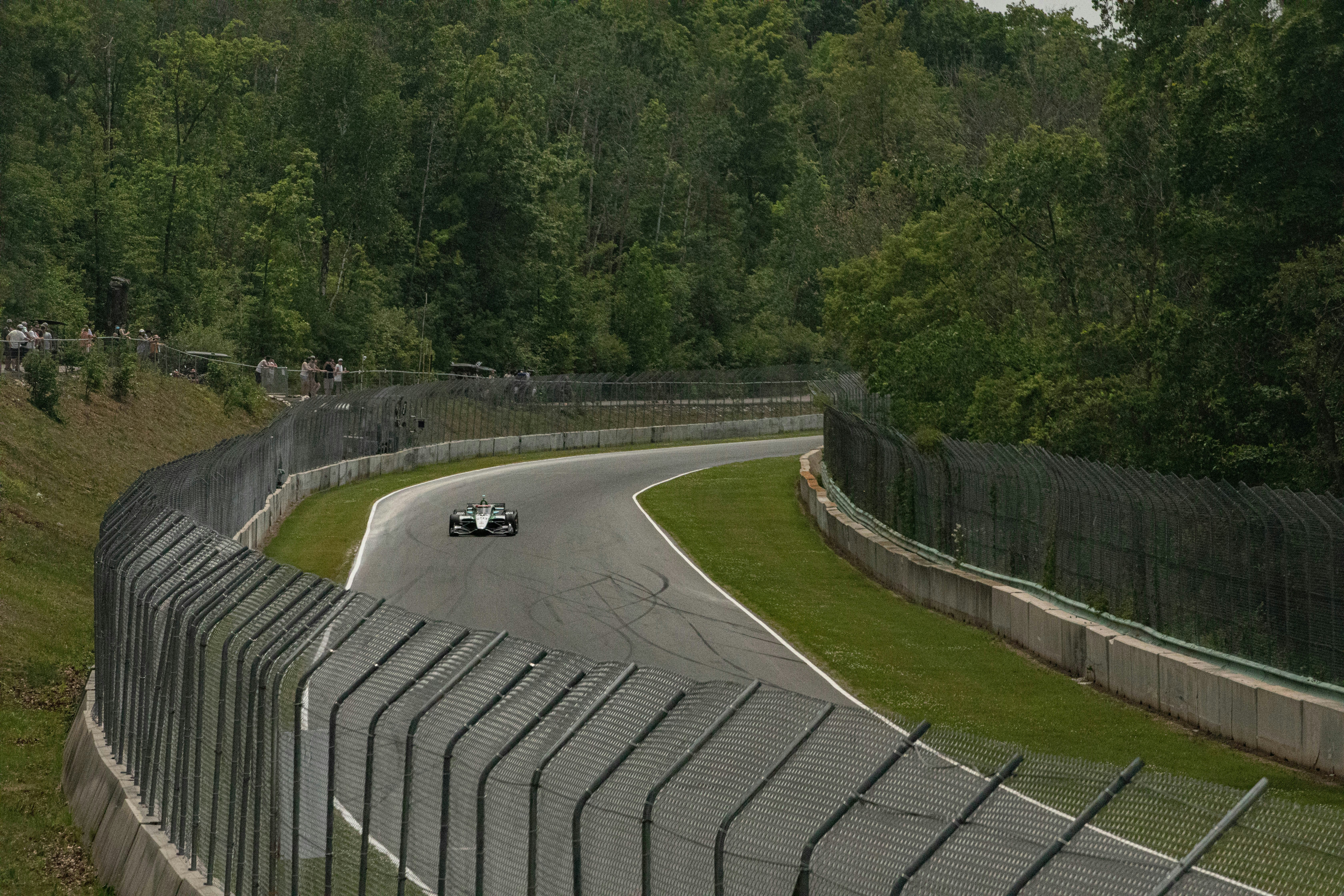 A race car speeds around a winding track.