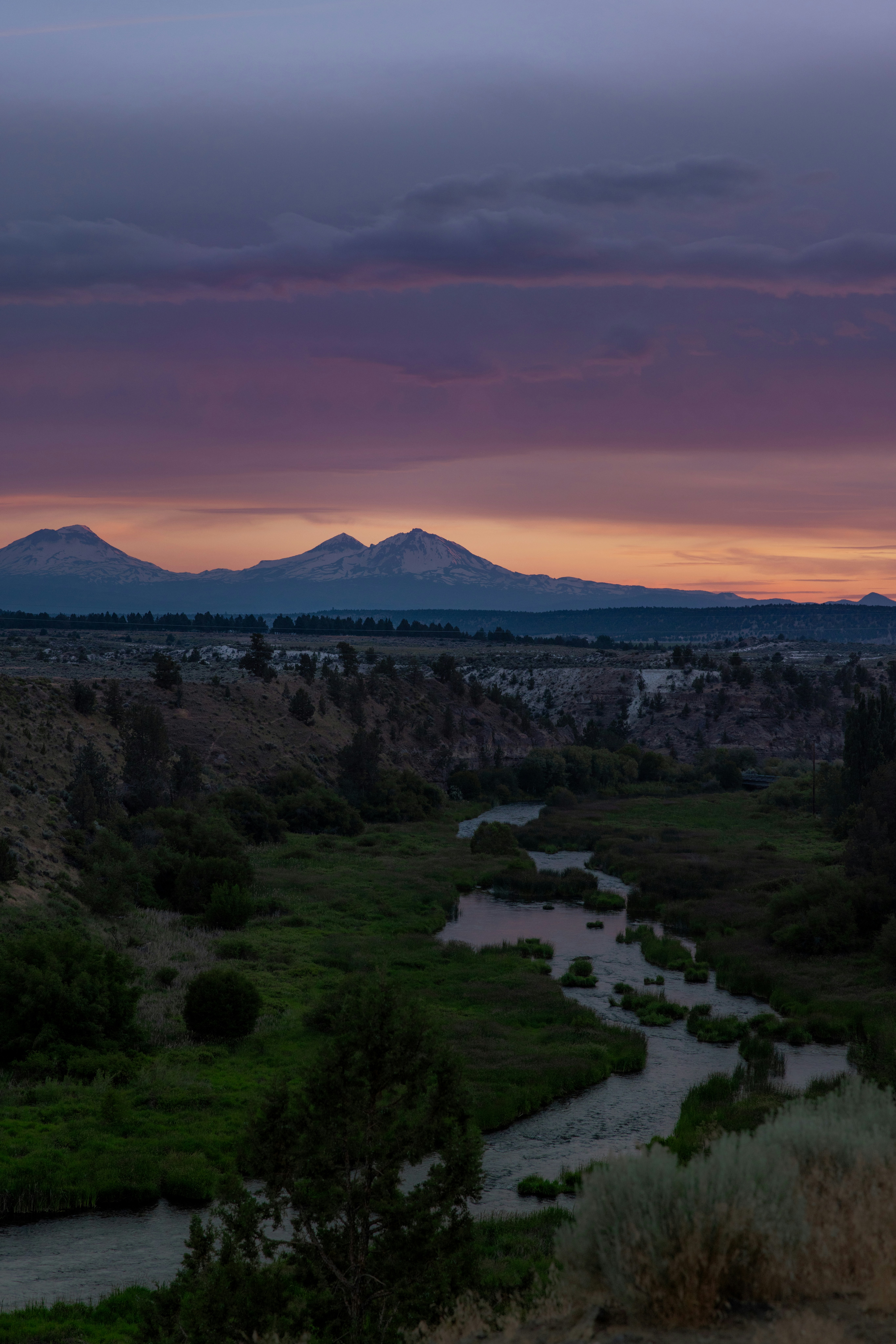Mountains, river and sunset create a vibrant landscape.