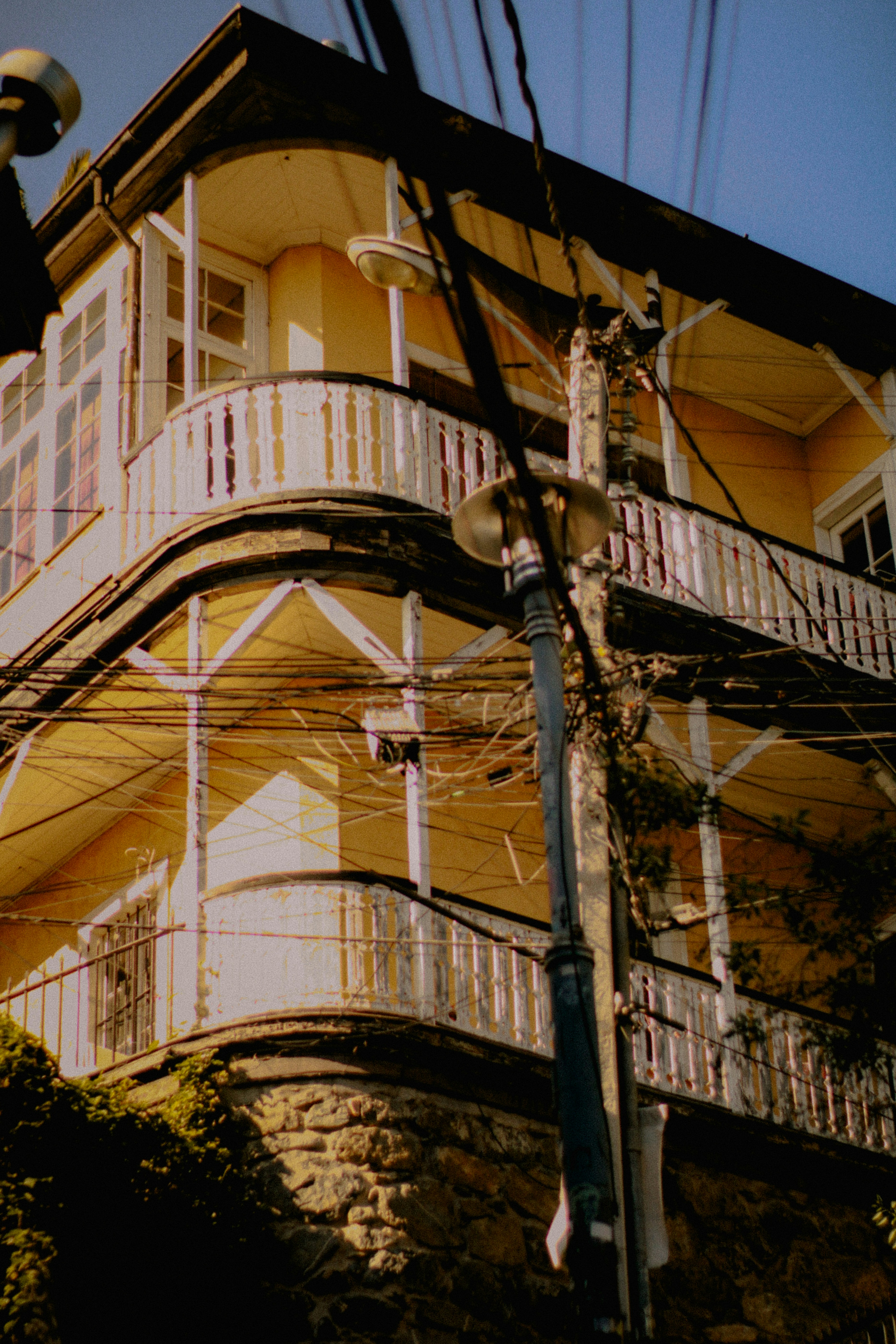 A beautiful yellow building with balconies.