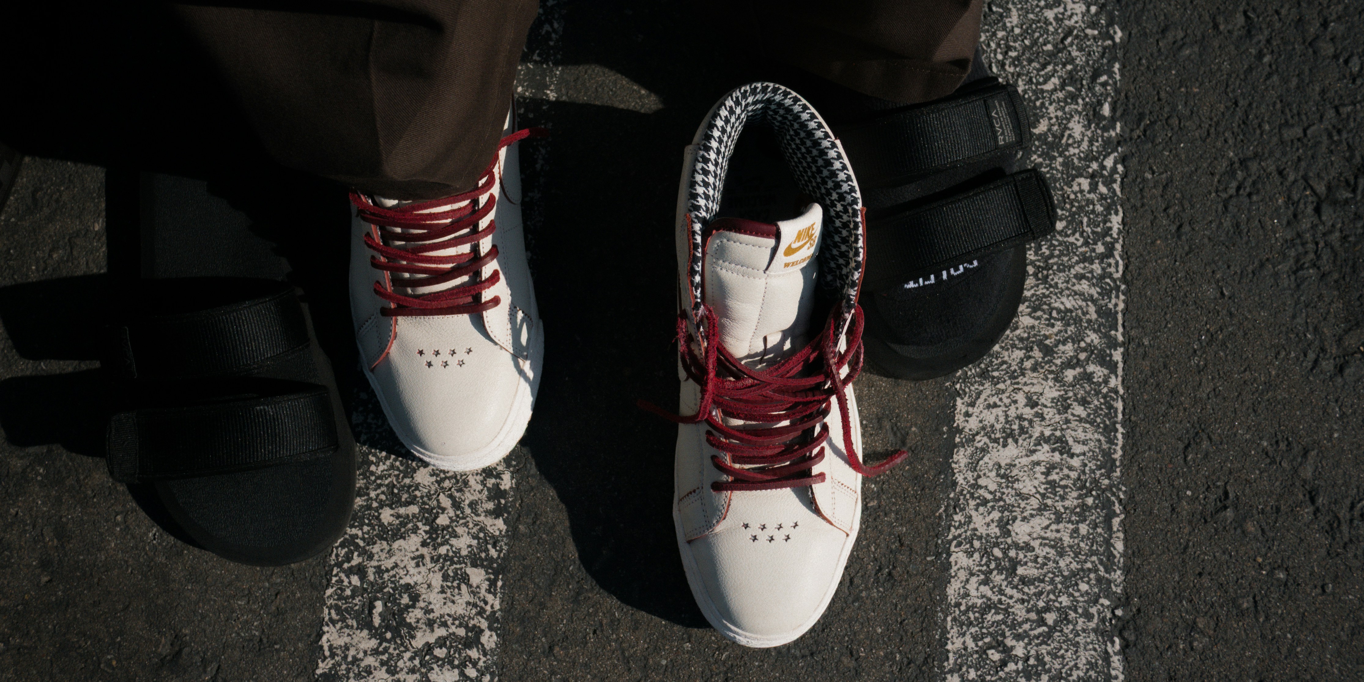 Shoes with red laces and a black sandal.