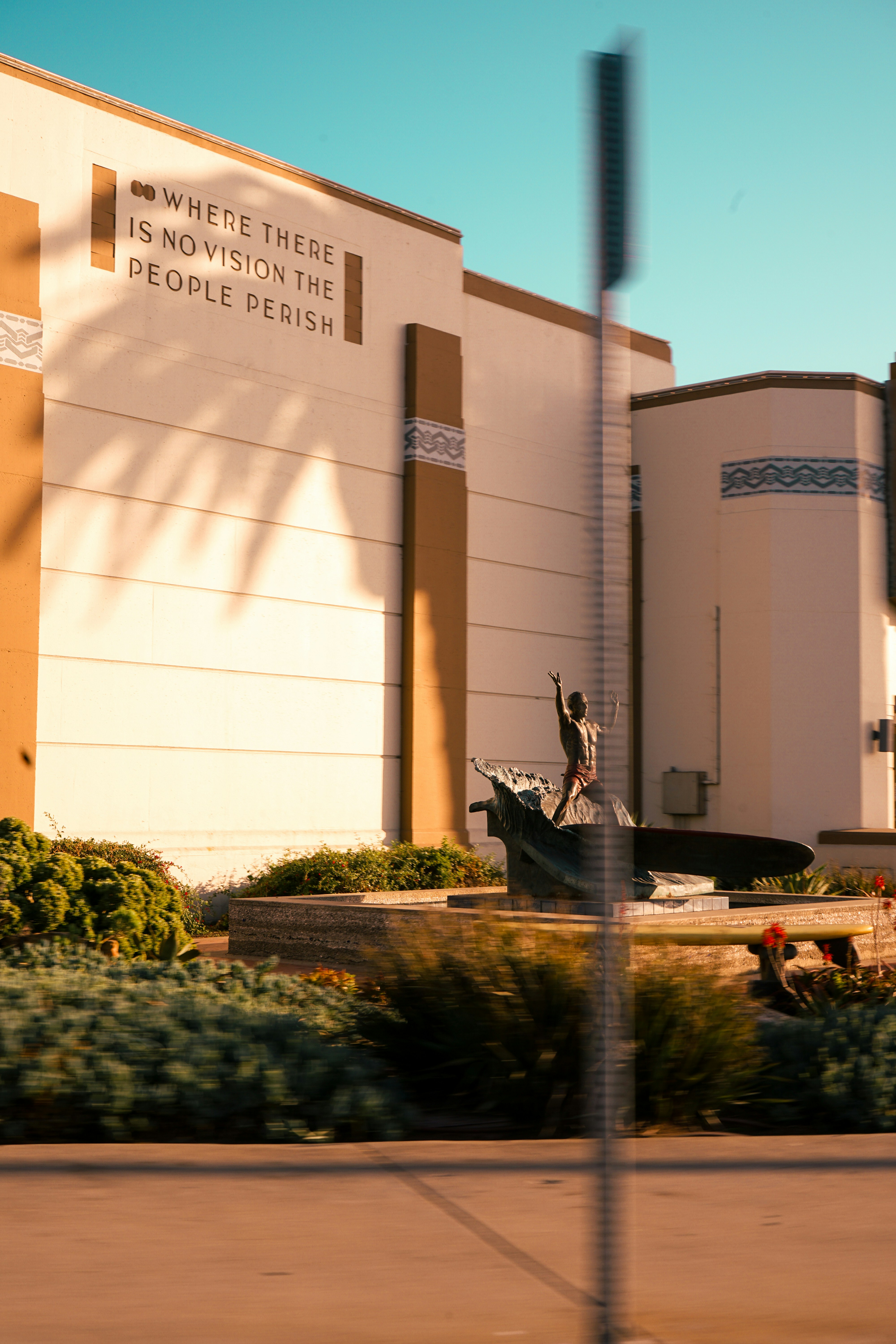 A building with a statue and a quote.
