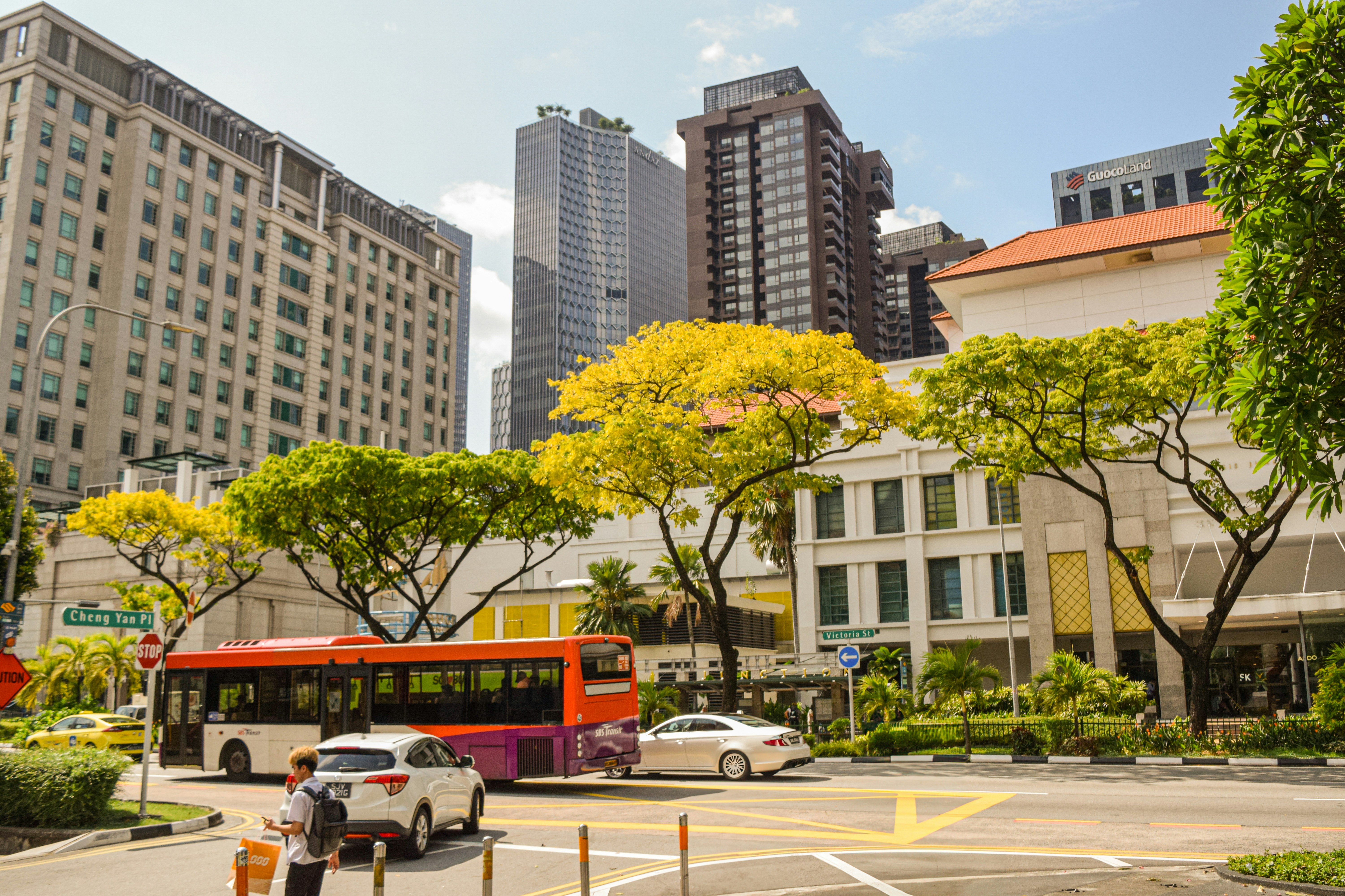 Buildings and a bus in a bustling city.