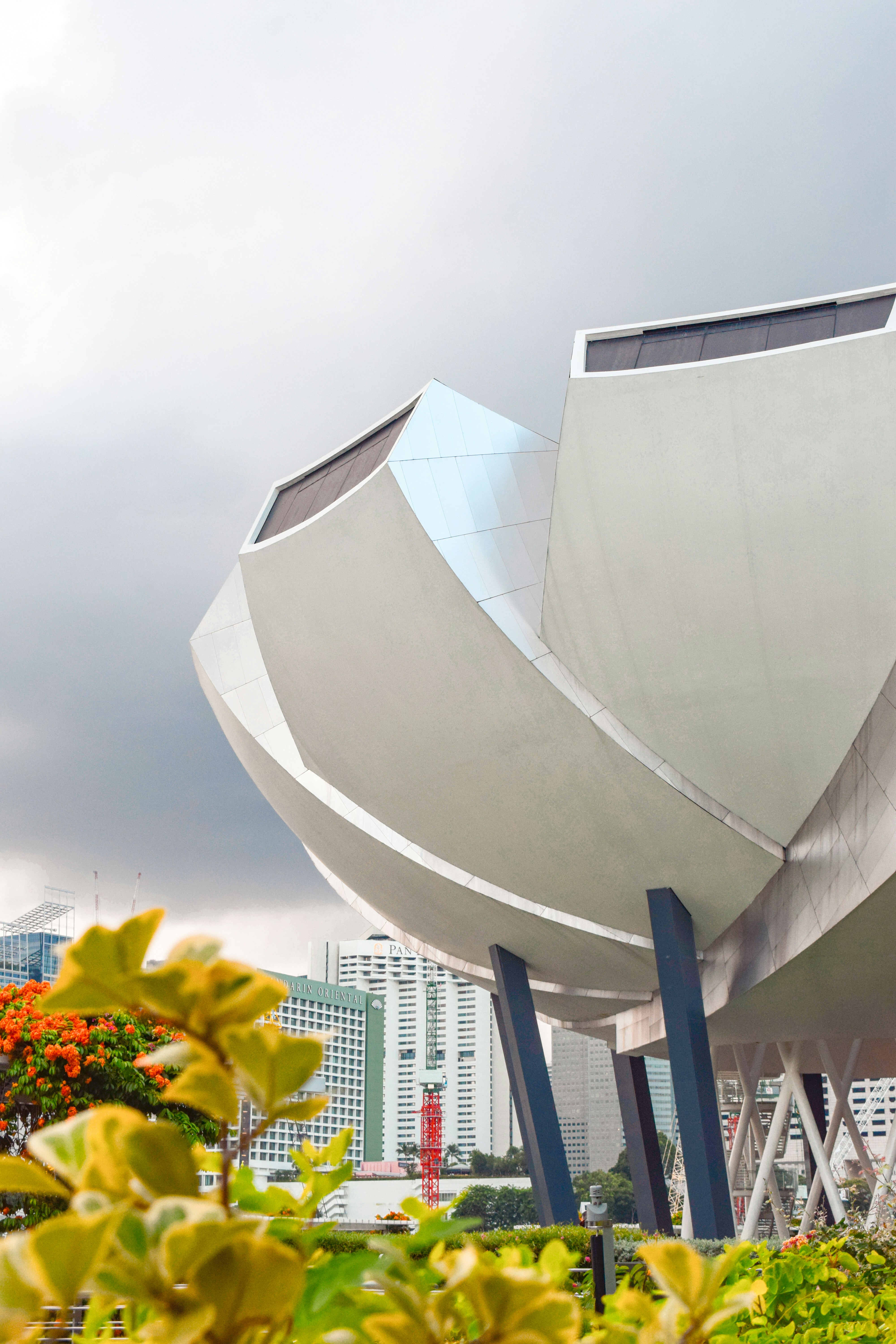 A modern, sculptural building on a cloudy day.
