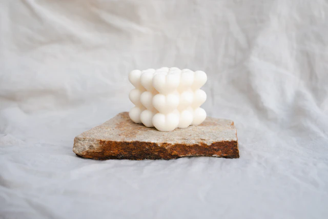 White bubble candle on a slab of stone