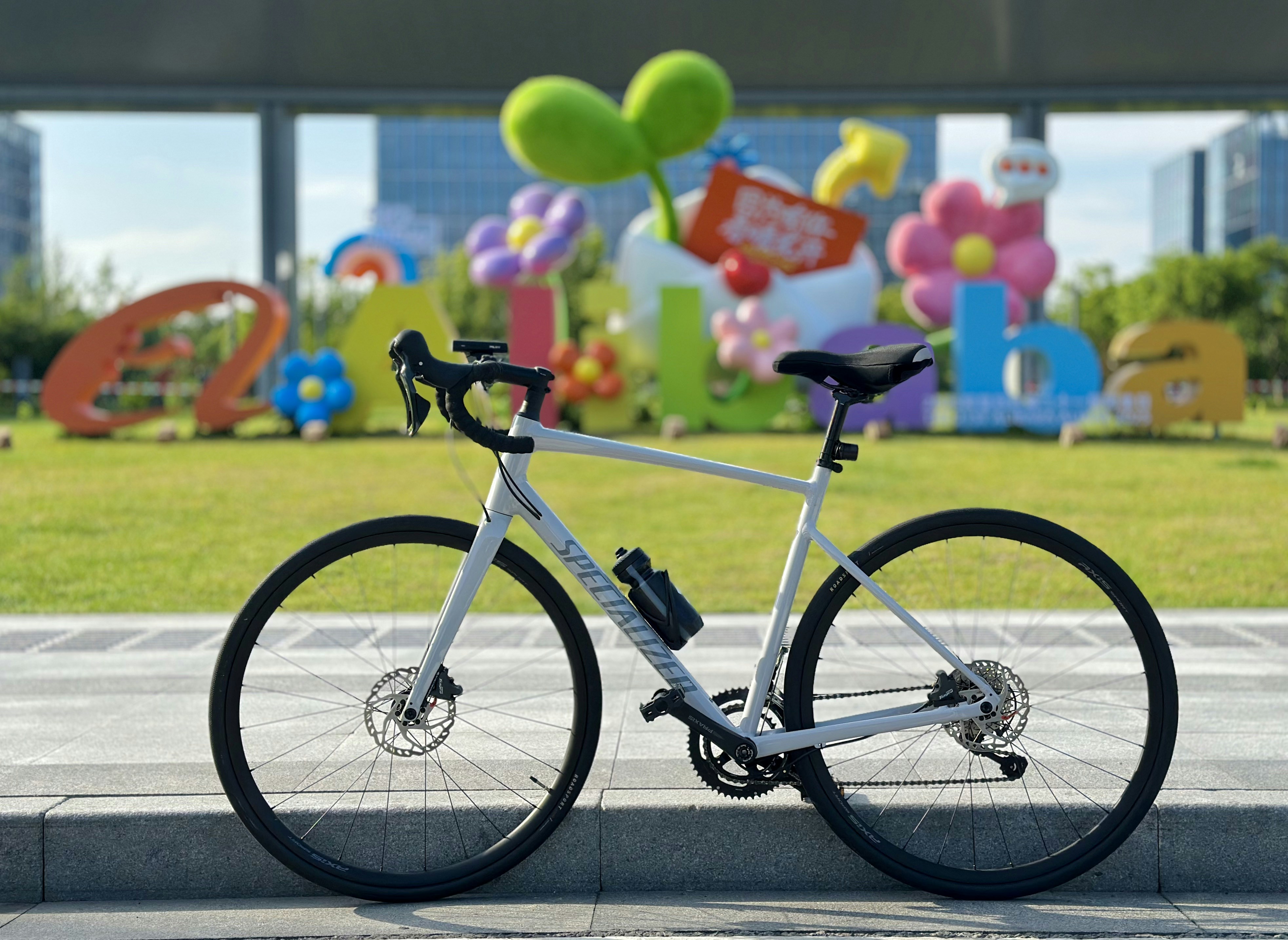 A bike is parked in front of colorful decorations.