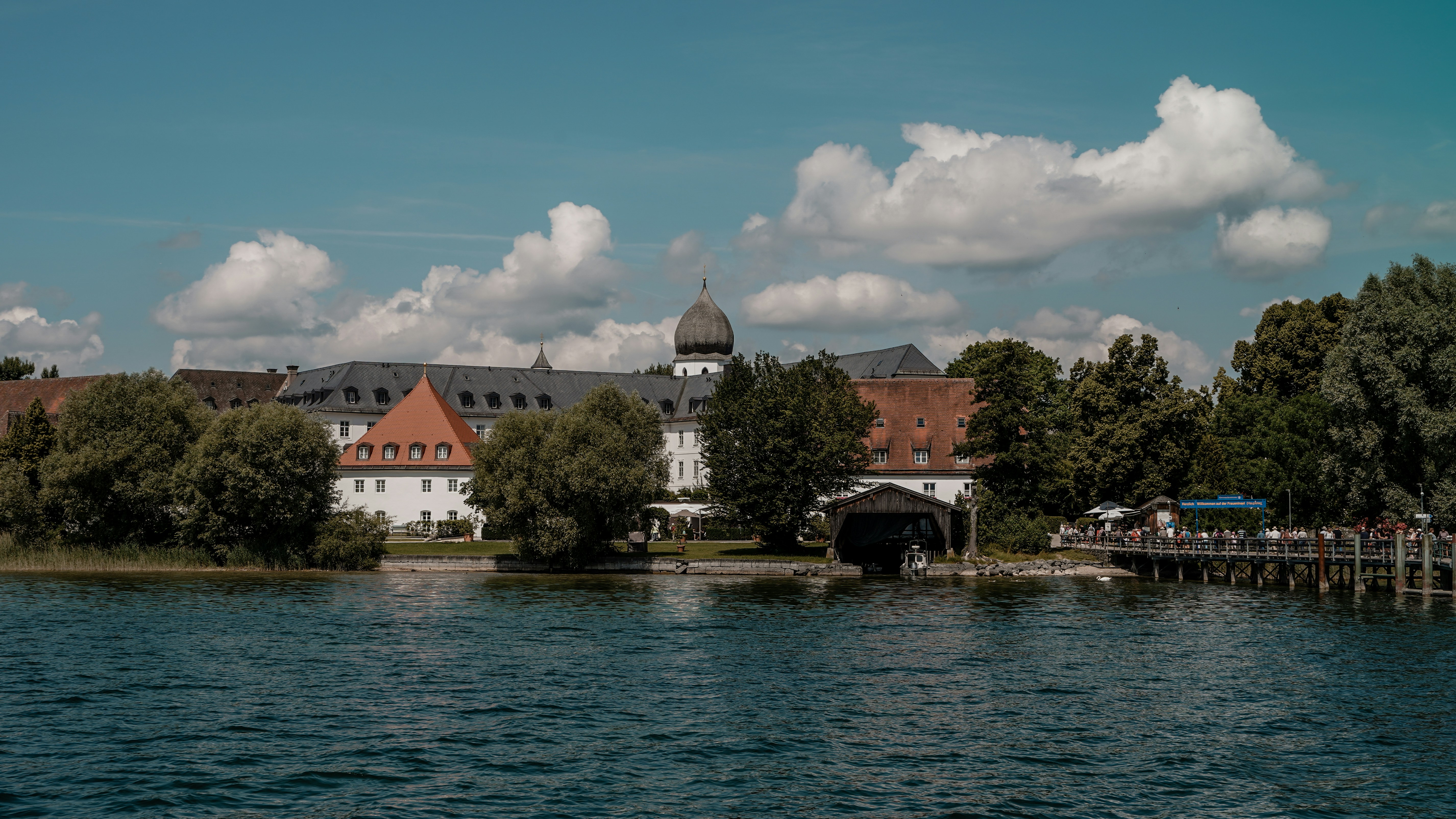 A beautiful building sits by the calm lake.