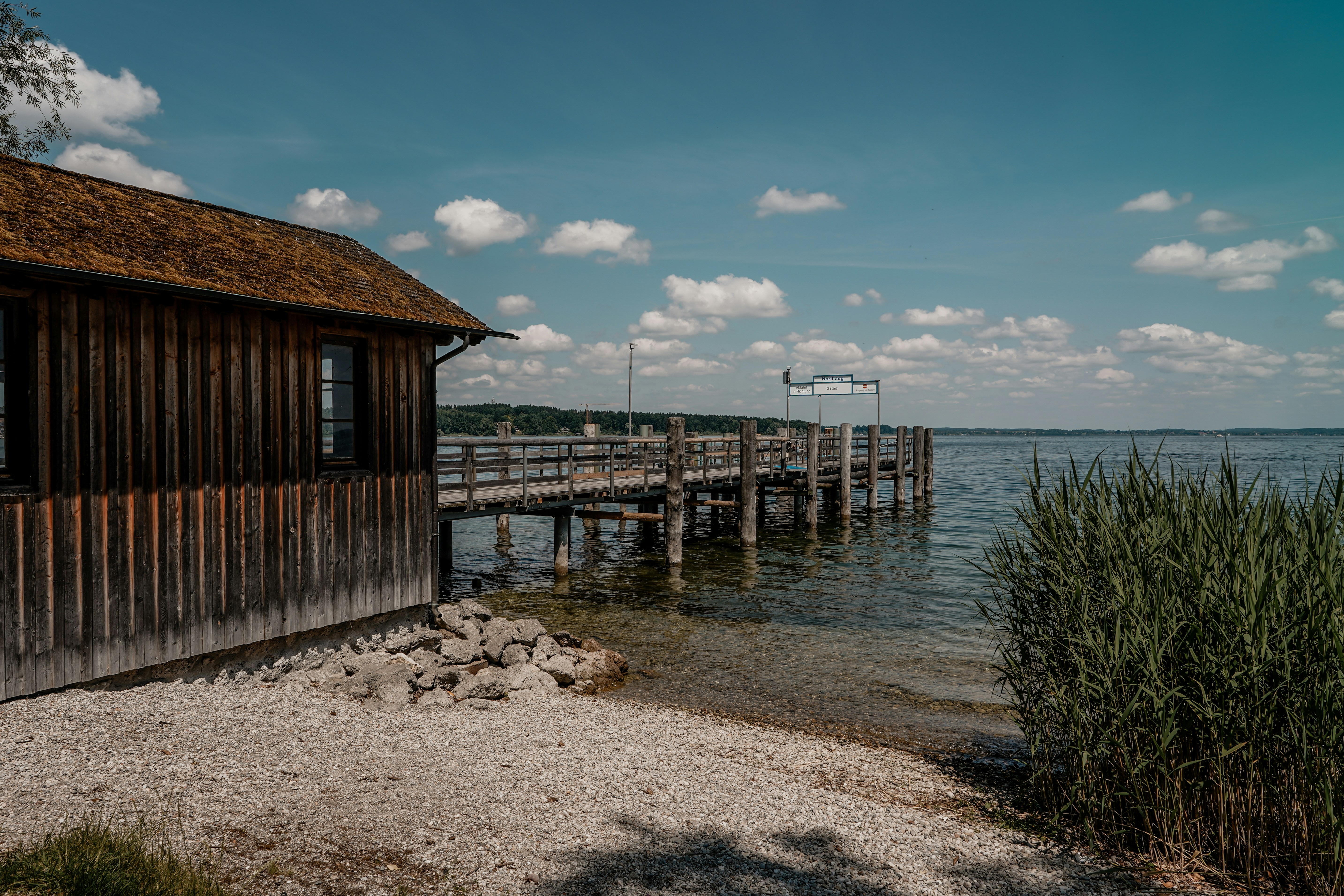 A wooden dock extends into the lake.