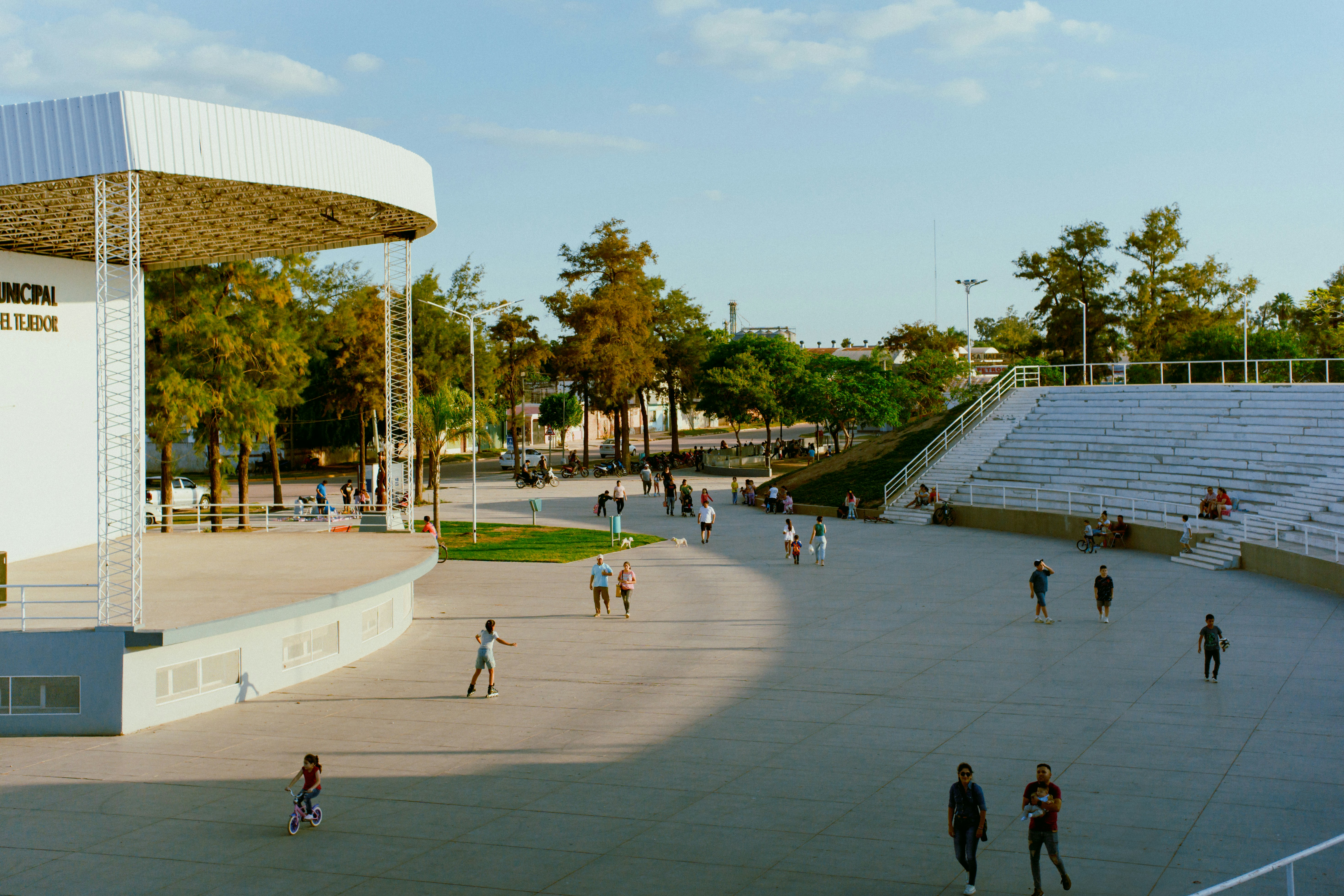 People enjoy a sunny day at an outdoor amphitheater.