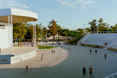 People enjoy a sunny day at an outdoor amphitheater.