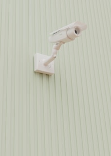 A security camera is mounted on a wall.