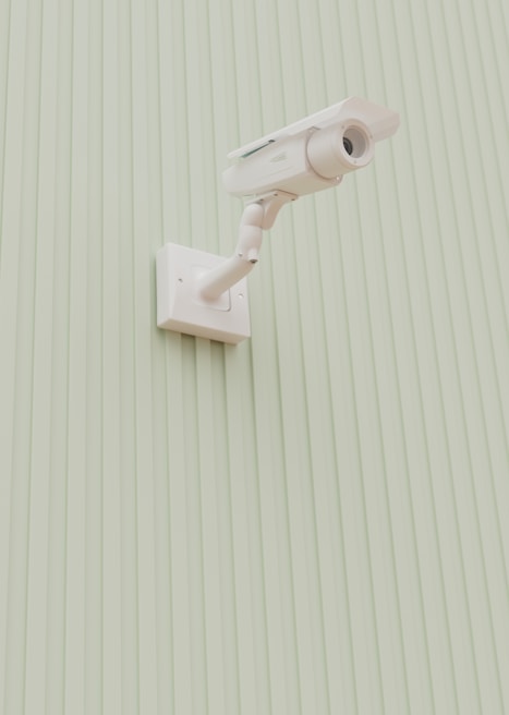 A security camera is mounted on a wall.