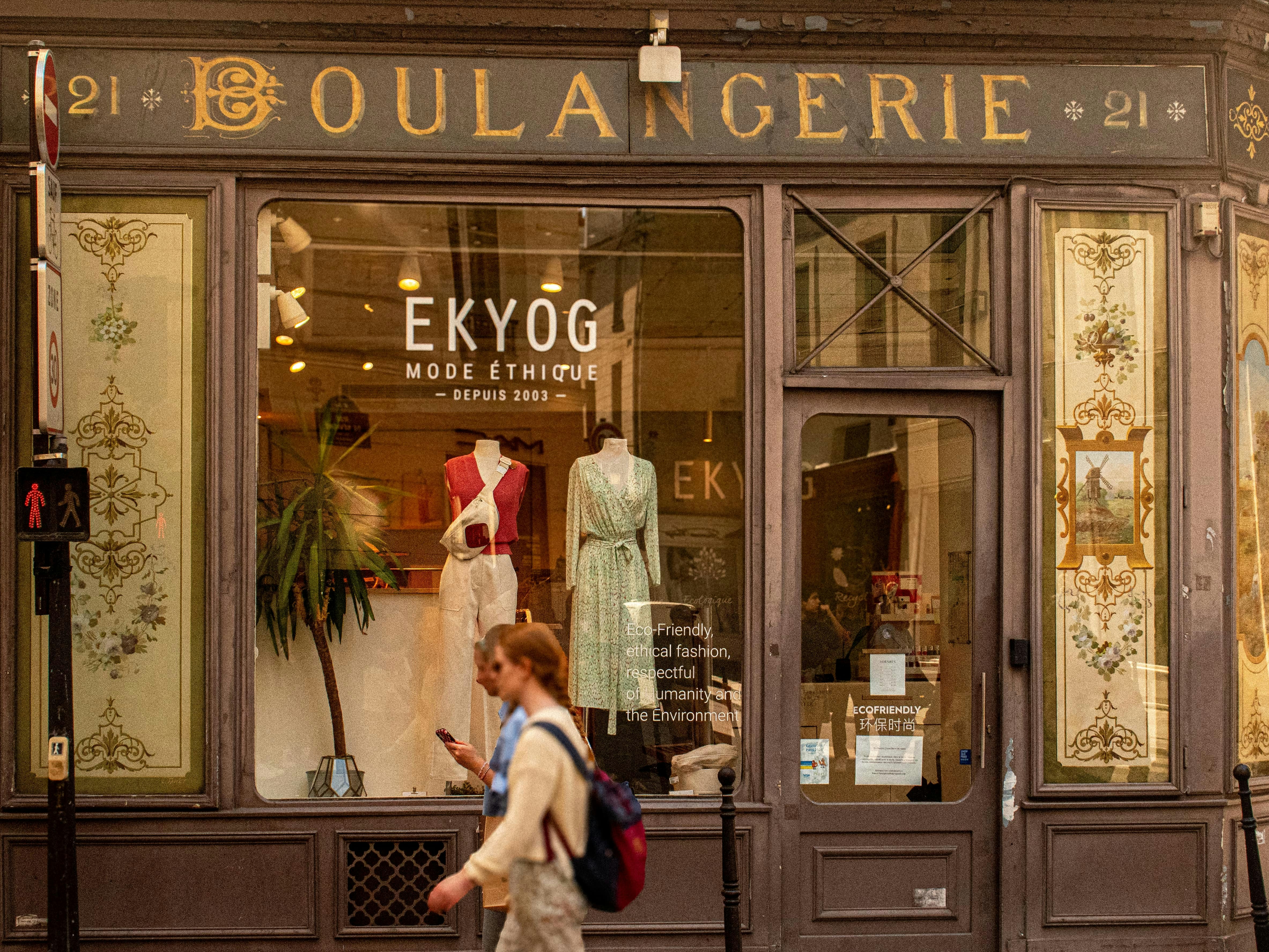 A parisian boutique with mannequins is shown.