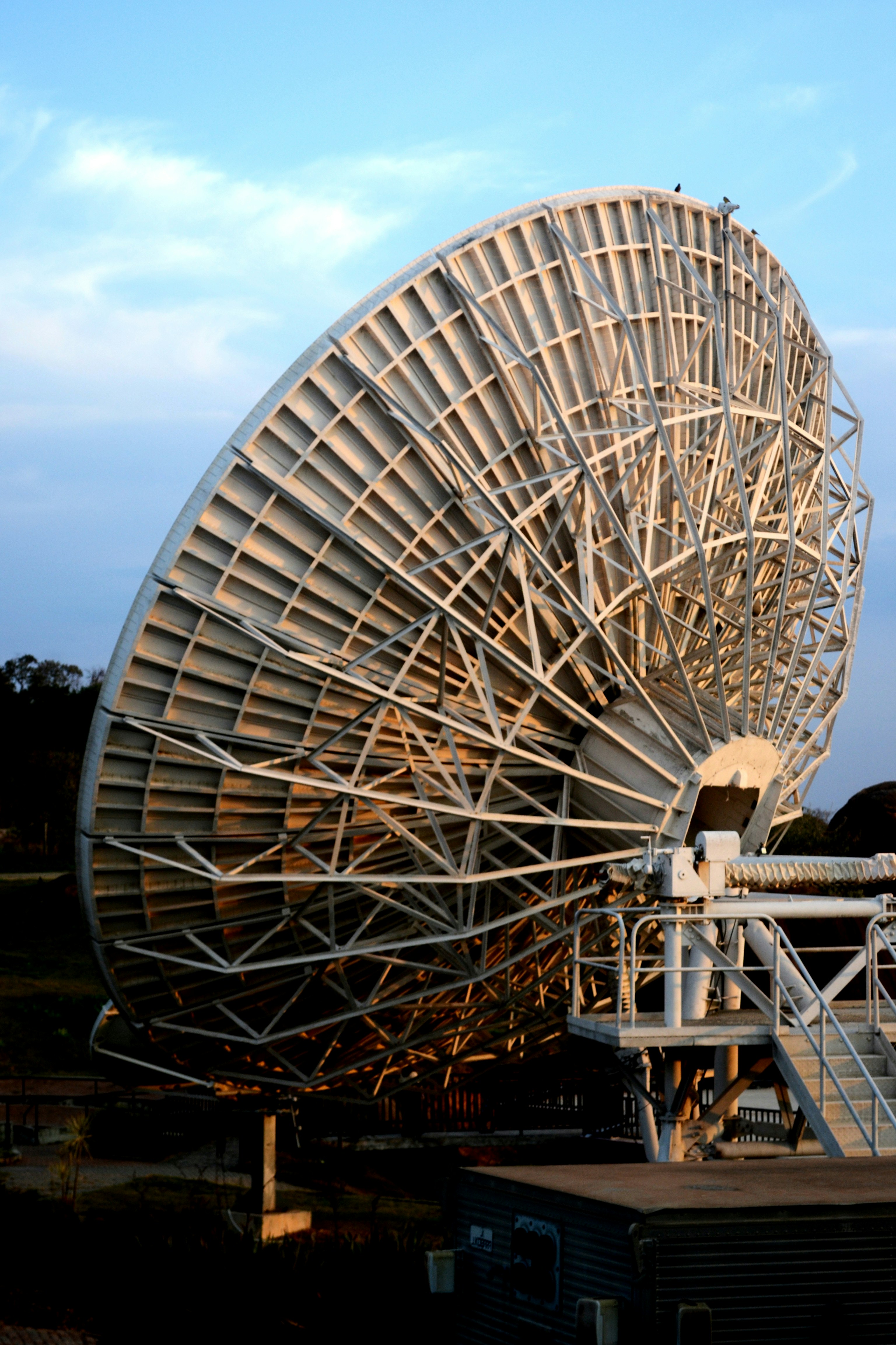 A large satellite dish receives signals.