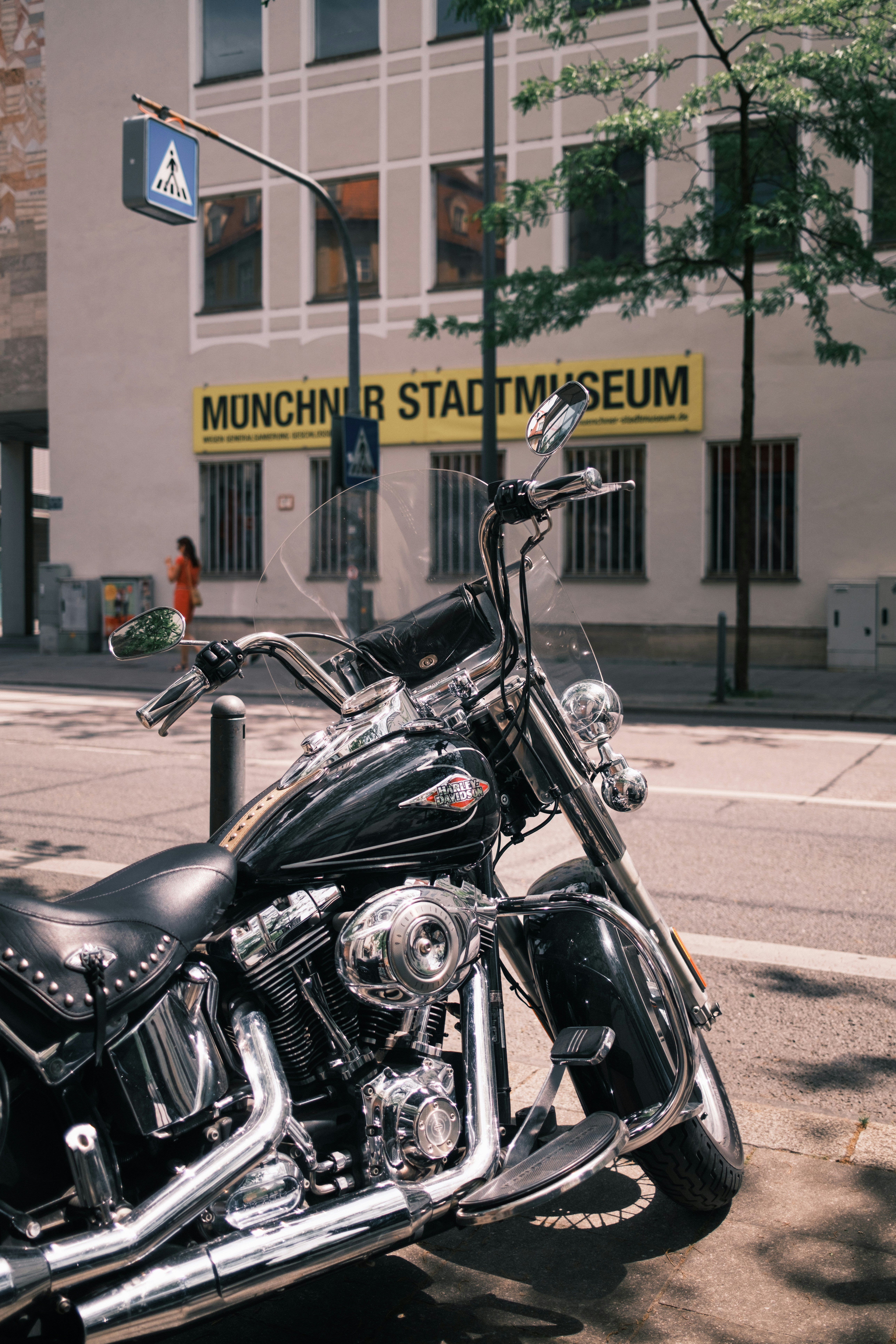 A motorcycle is parked in front of a museum.