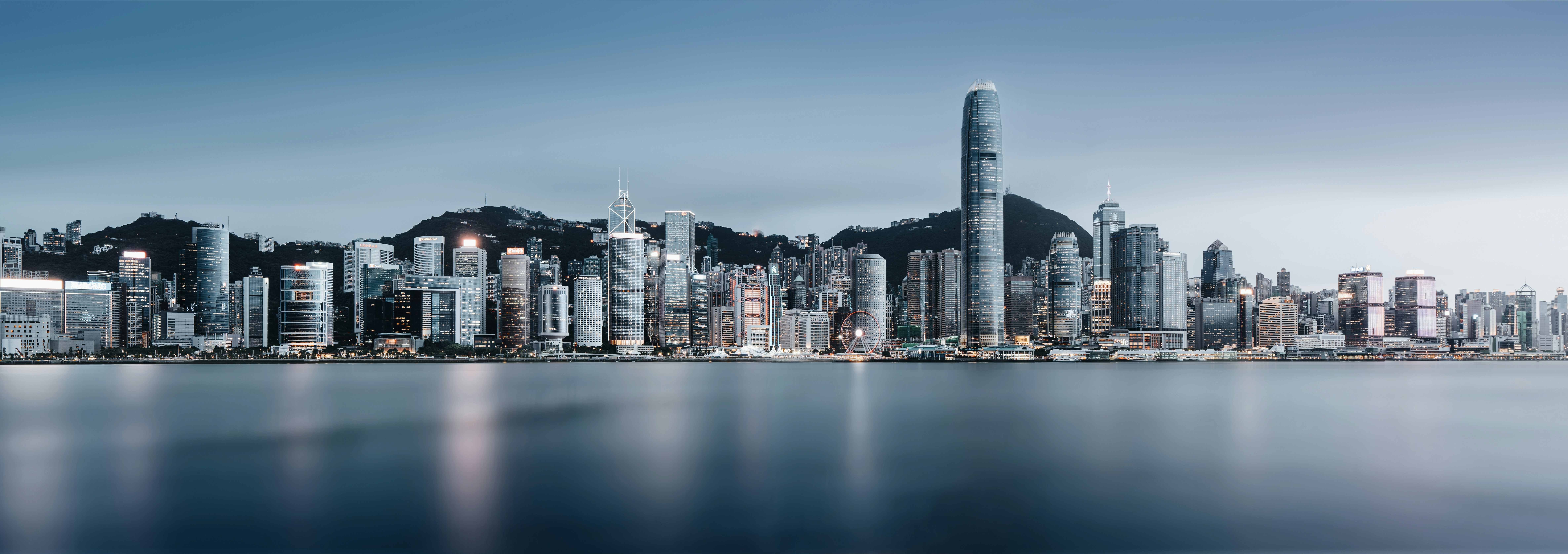 A skyline reflects in water.