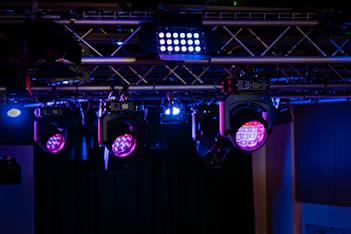 Stage lights illuminating in purple and blue.