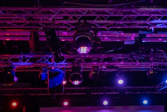 Stage lights illuminating a colorful event space.