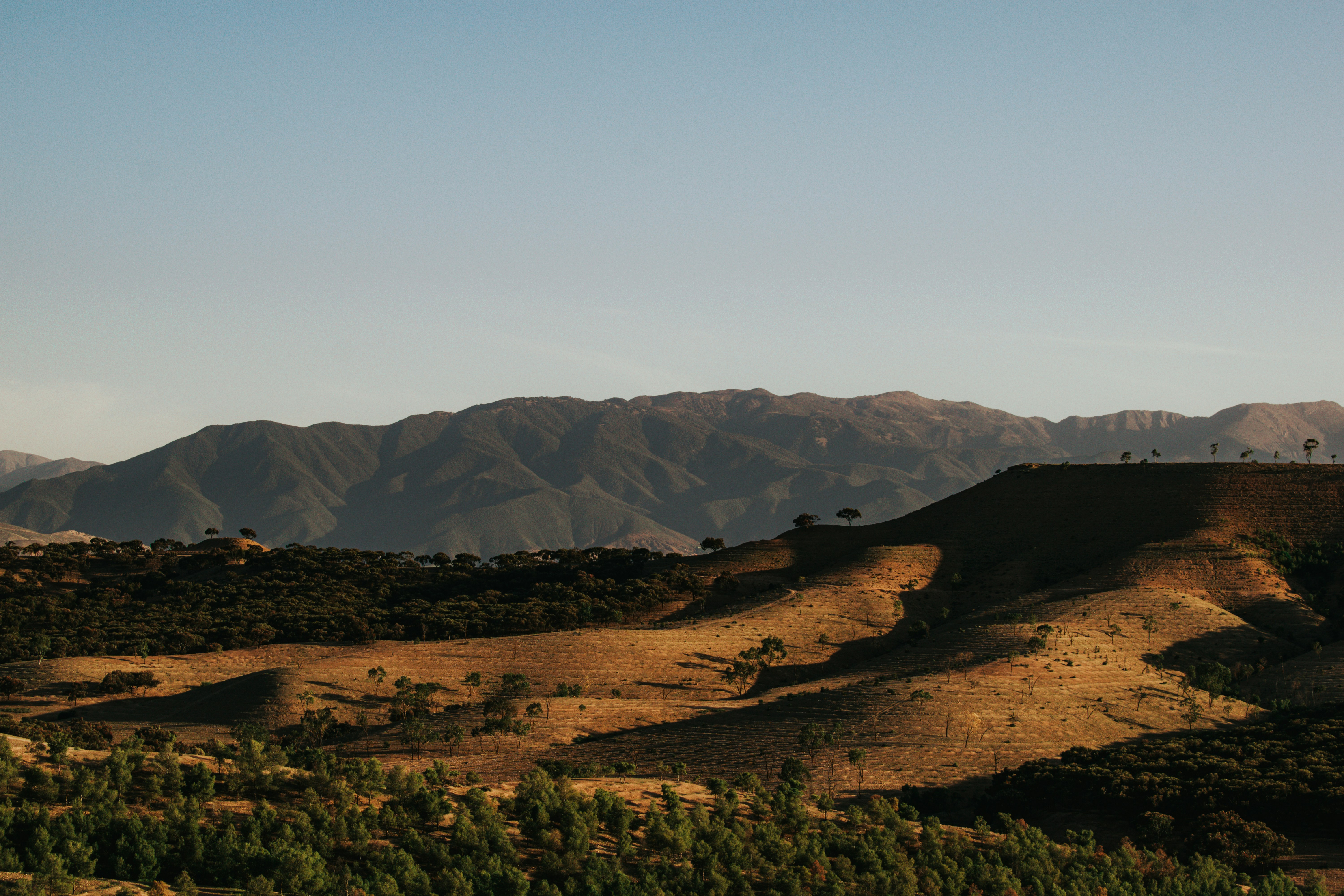 Hills and mountains under a clear blue sky