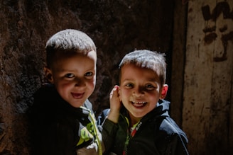 Two smiling children pose together for a photo.