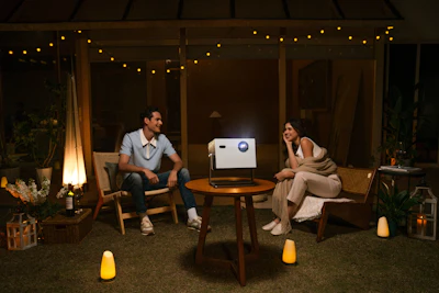 A couple enjoys a movie night outdoors.