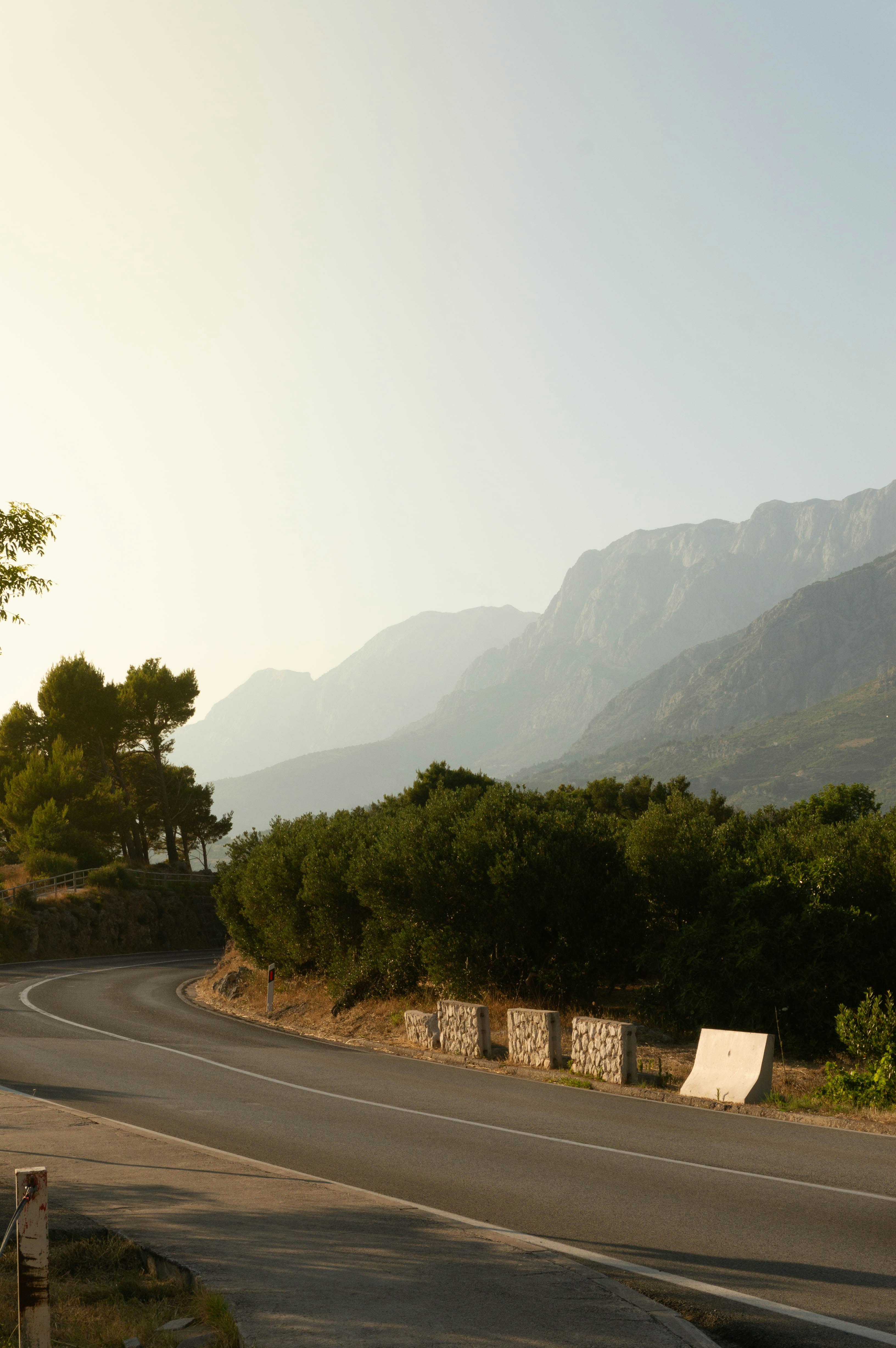 A winding road leads towards distant mountains.
