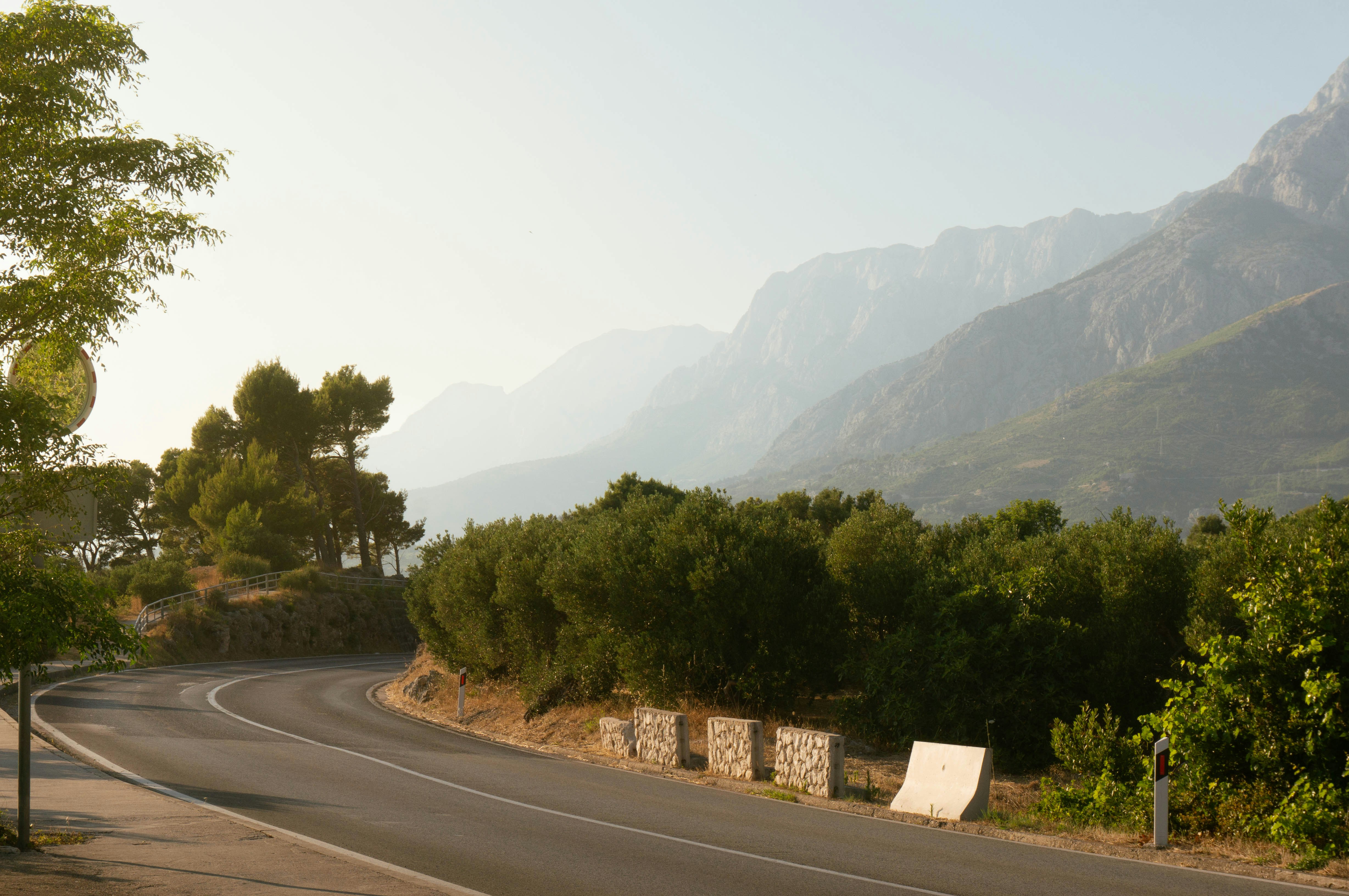 A winding road leads toward mountains.