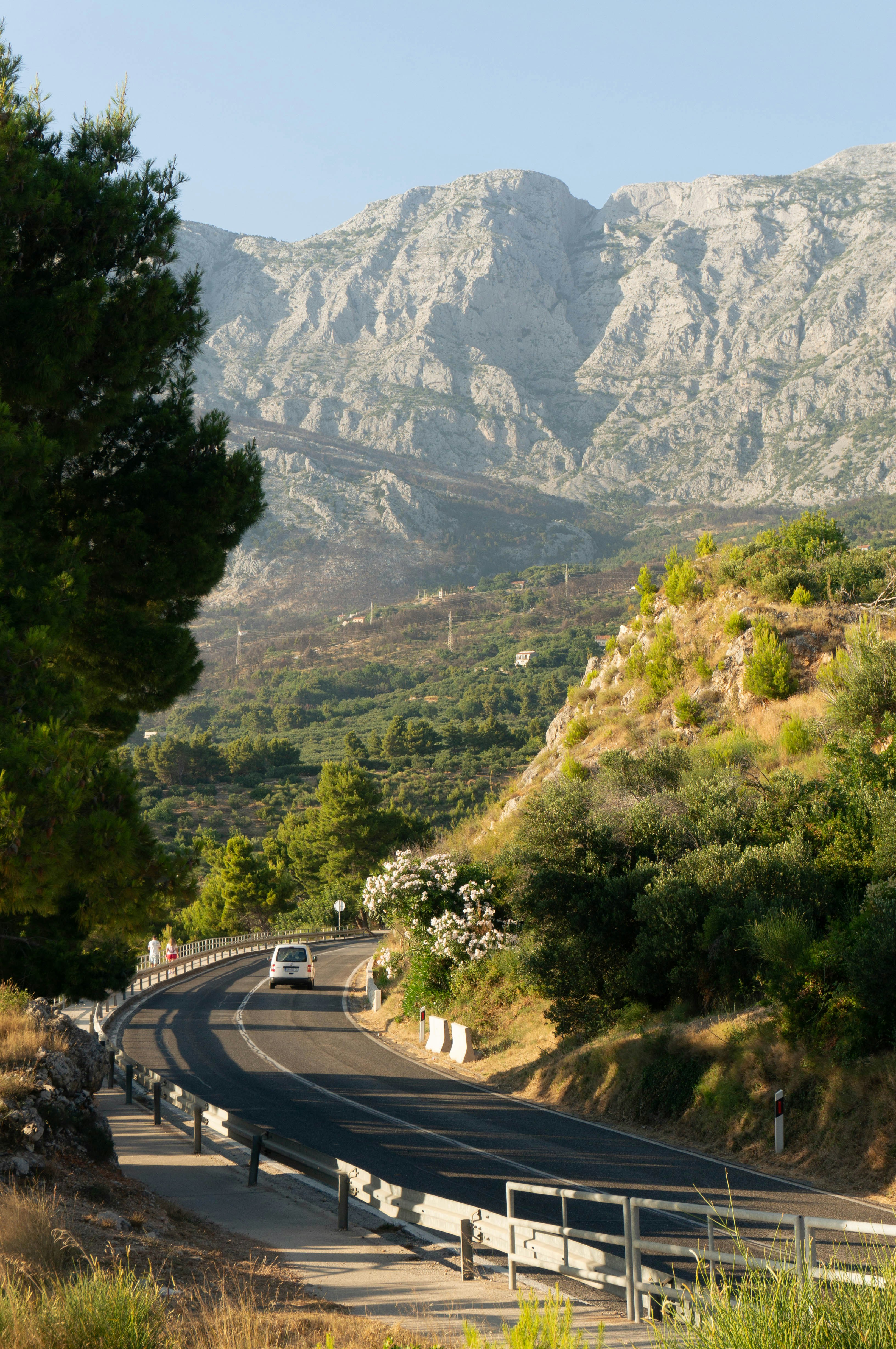 A winding road leads towards mountains.