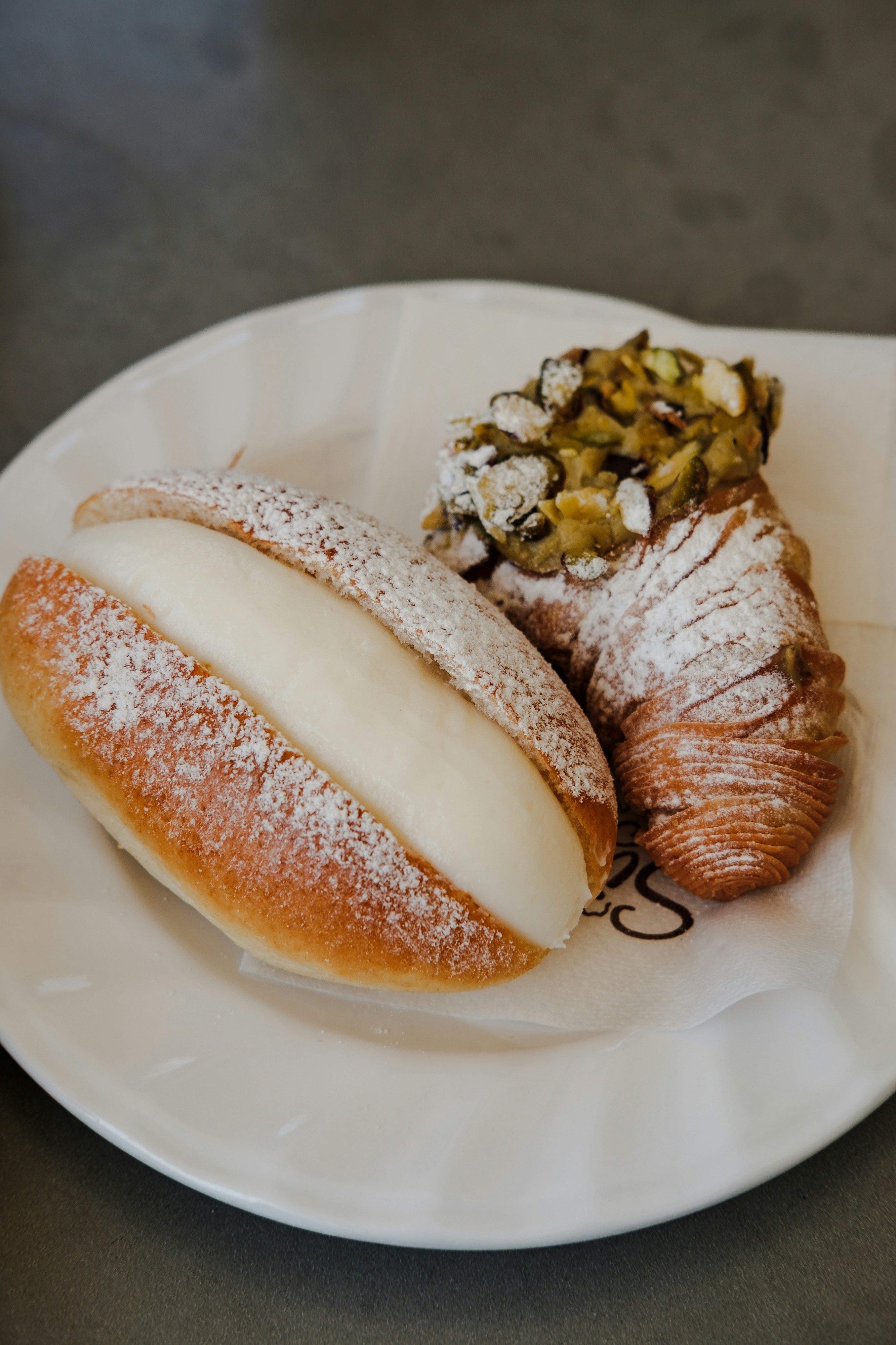 Fresh pastries are displayed on a white plate.