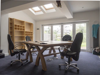 Spacious office with desk, chairs, and bookshelves