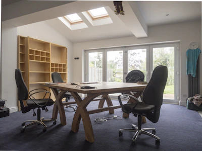 Spacious office with desk, chairs, and bookshelves