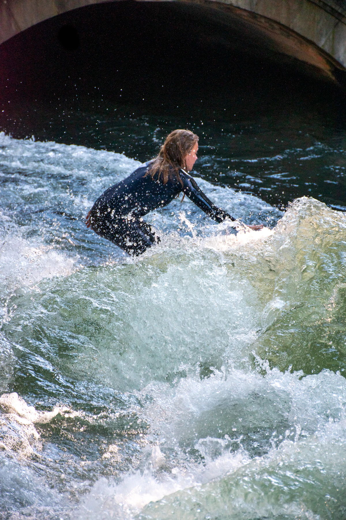 Woman surfing a standing river wave