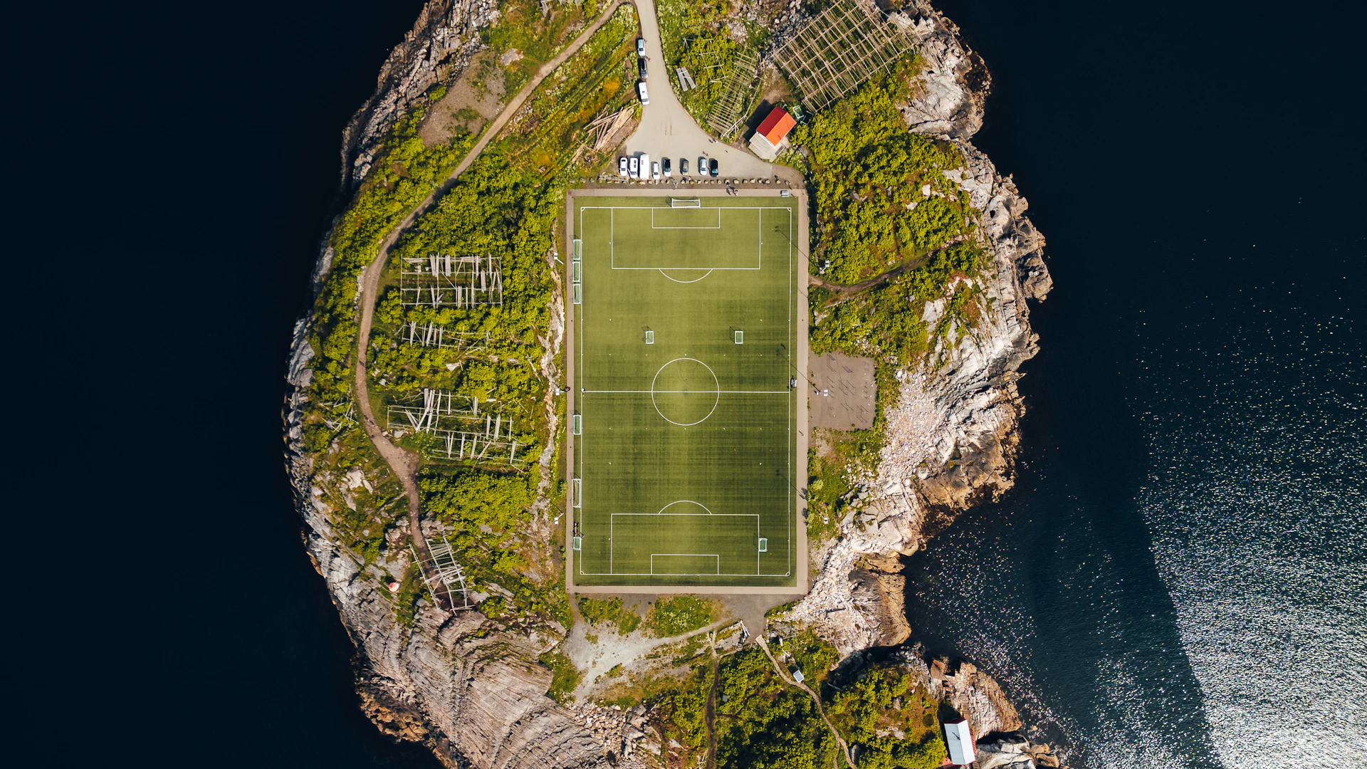 An island football field stands amidst water.