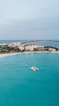 Aerial view of a tropical island with turquoise water.