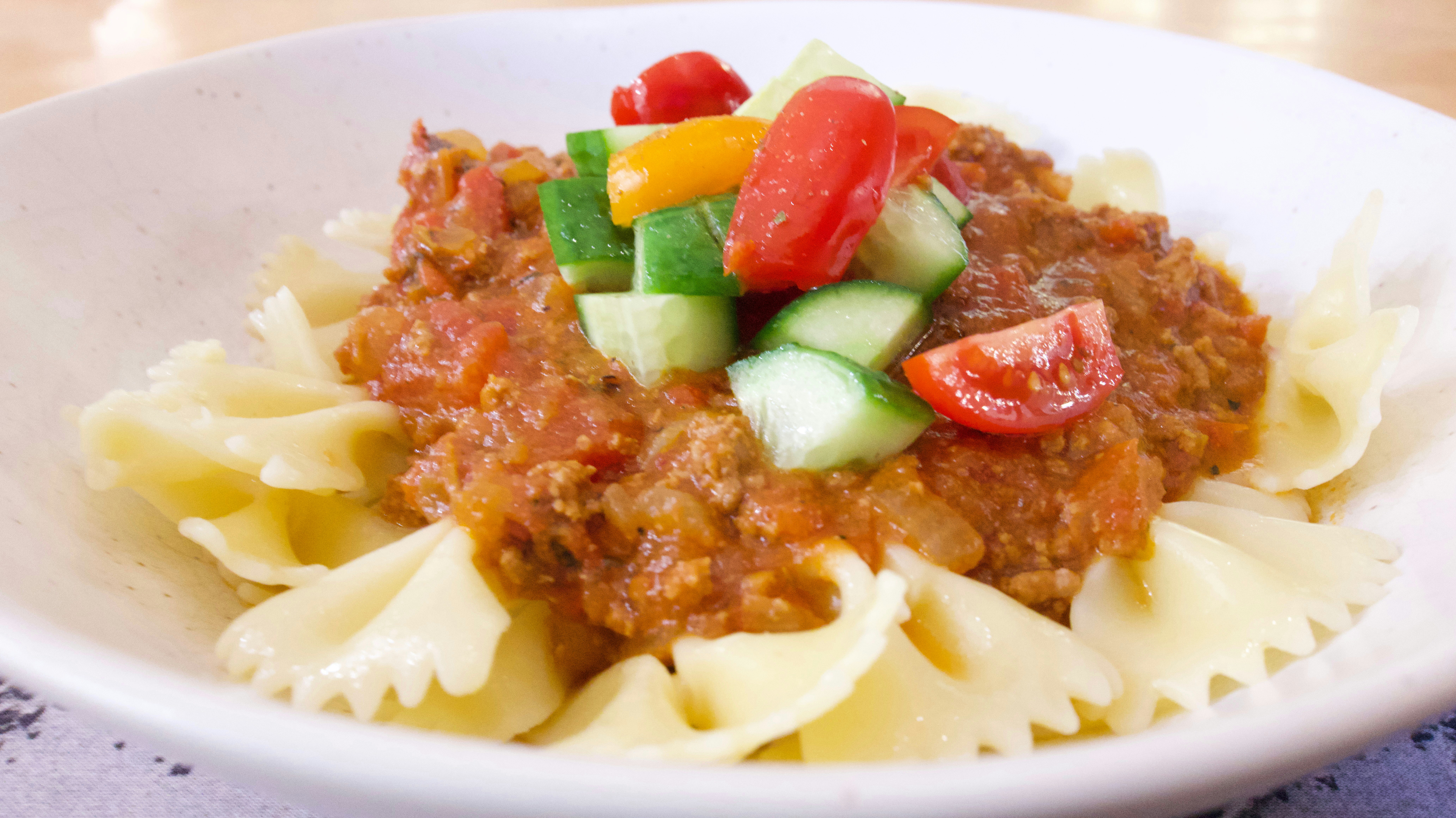 Pasta with sauce and fresh vegetables.