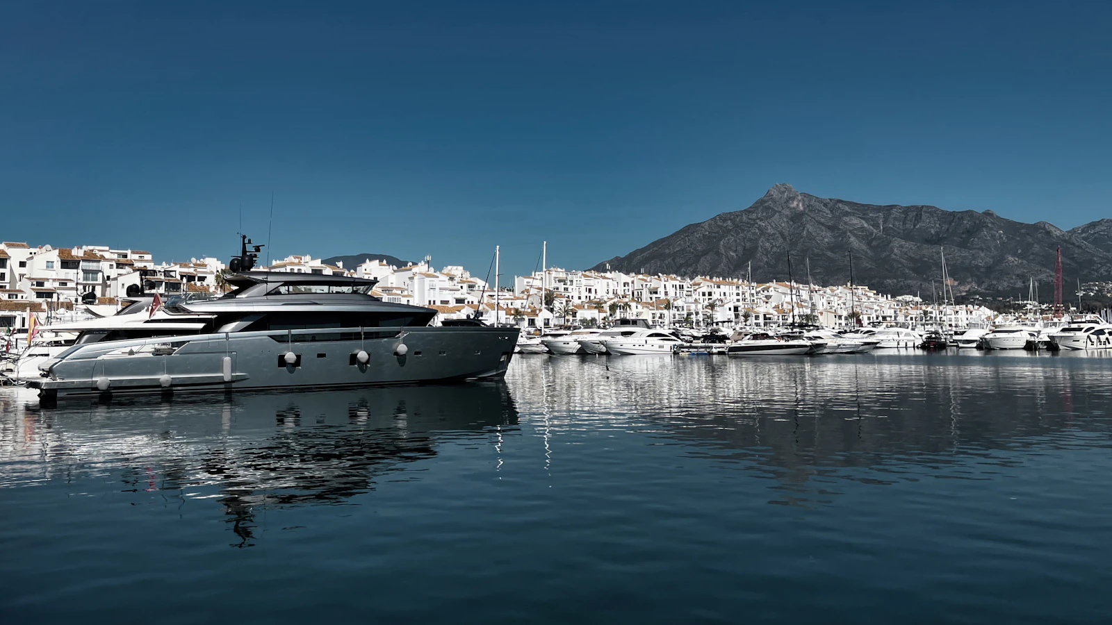 Large luxury motor yacht exceeding 80 feet moored in Puerto Banús