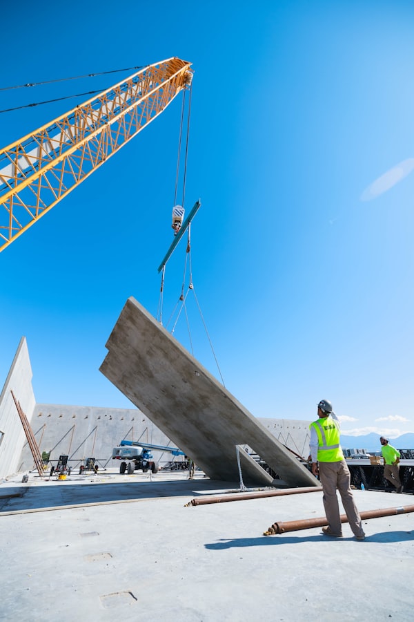 Crane lifting a heavy load under supervision, representing lifting equipment inspection