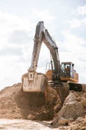 An excavator scoops dirt at a construction site.