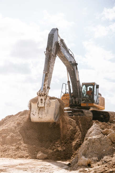 An excavator scoops dirt at a construction site.