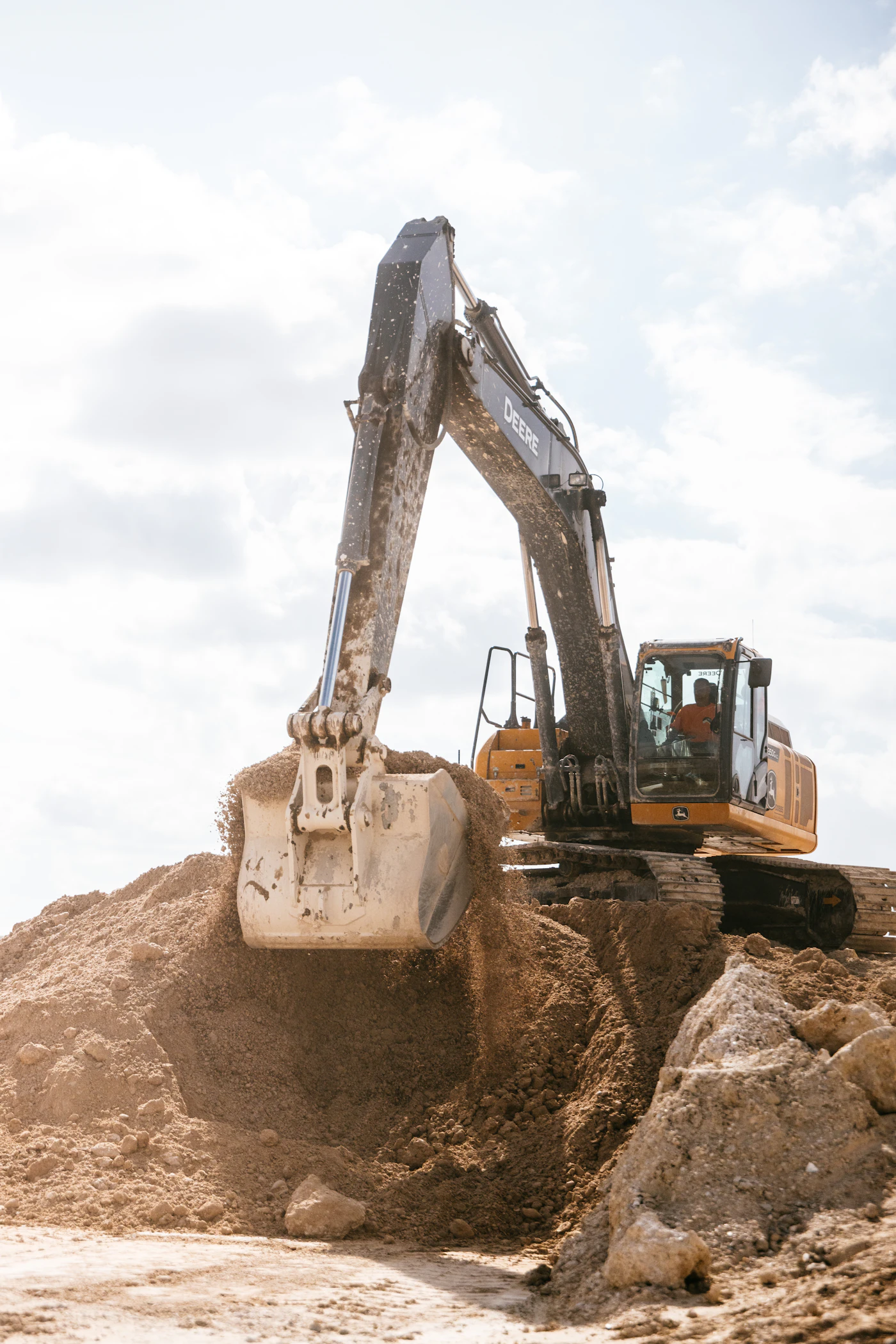Excavator dumping excavated earth during site preparation