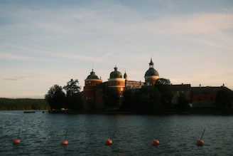 A beautiful castle sits along the water.