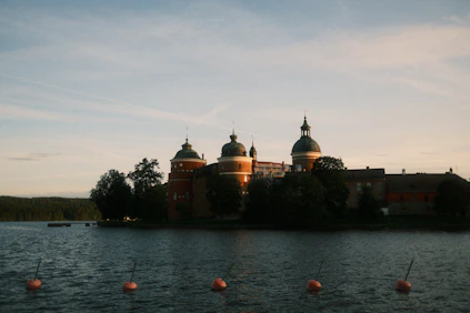 A beautiful castle sits along the water.
