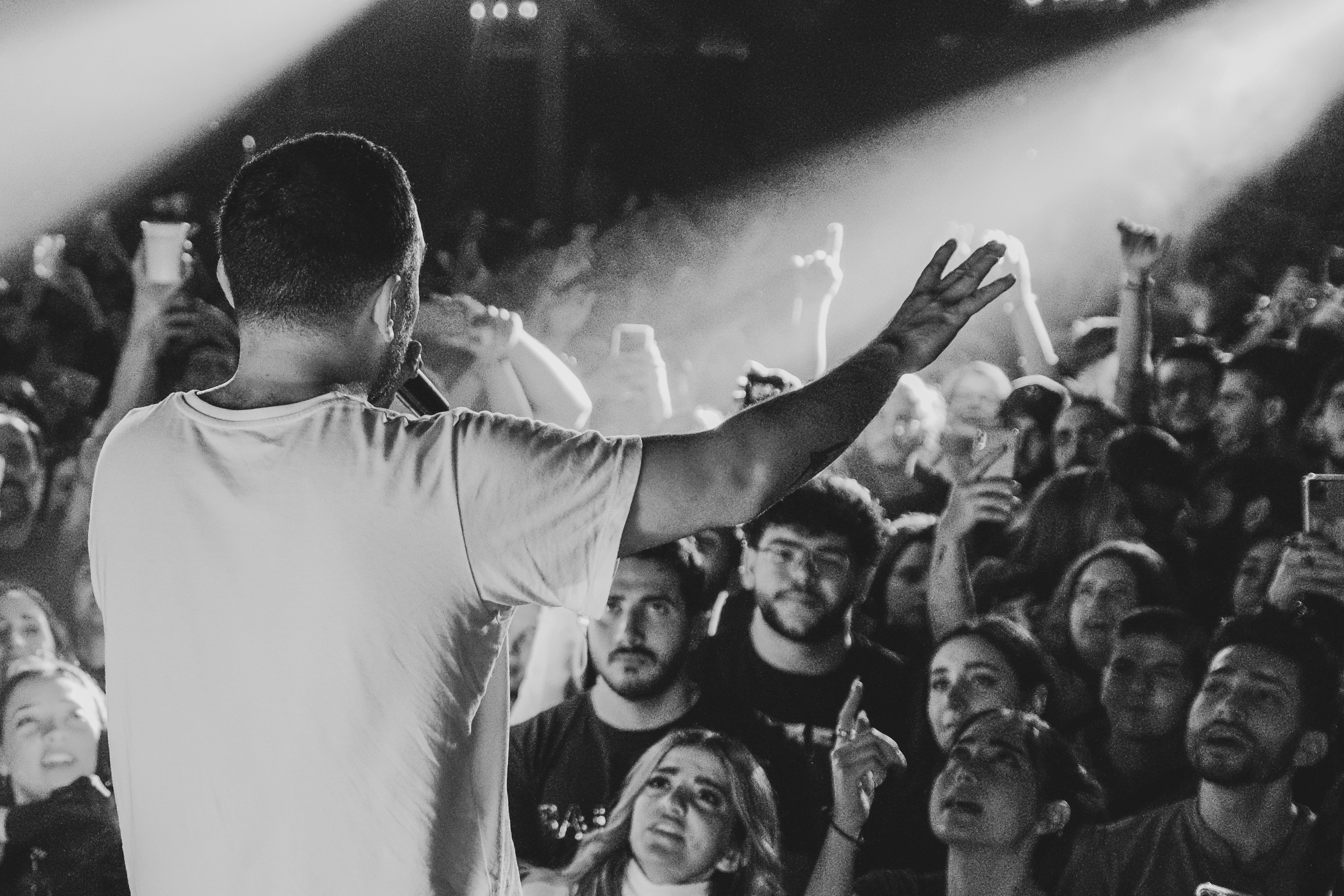 A performer engages with the energetic audience.