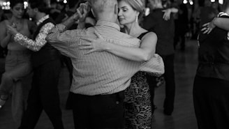 People are dancing the tango on a crowded dance floor.